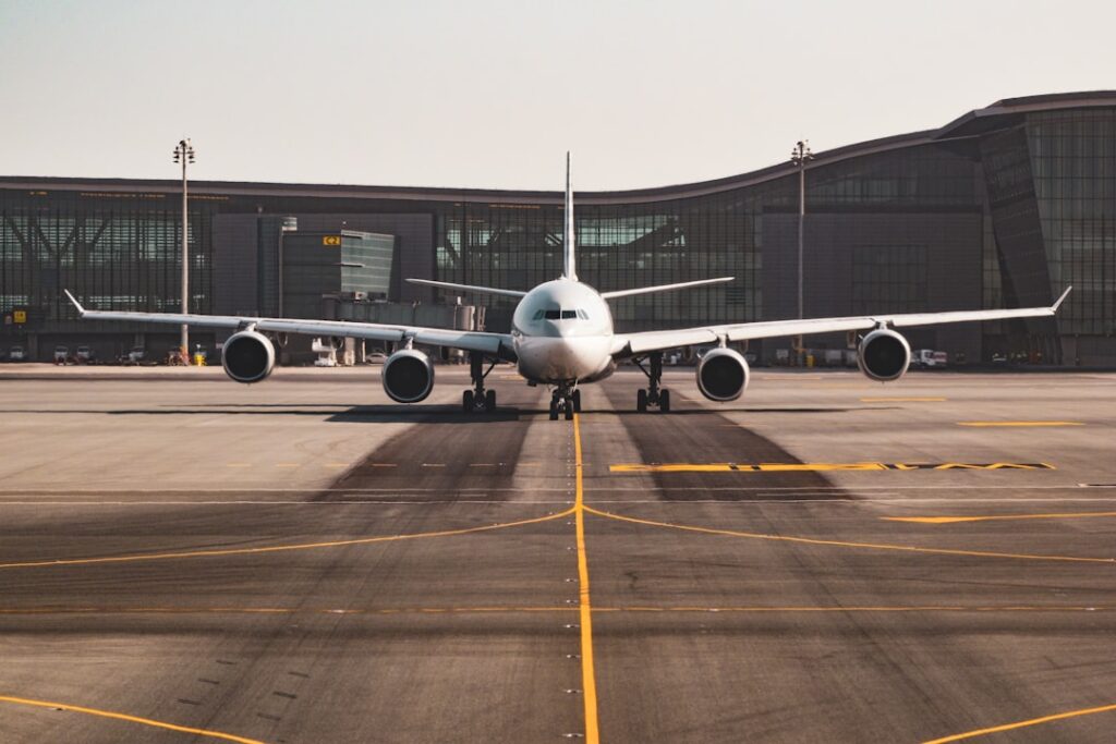 A professional setting with an aircraft in the background, showcasing a team discussing management strategies.