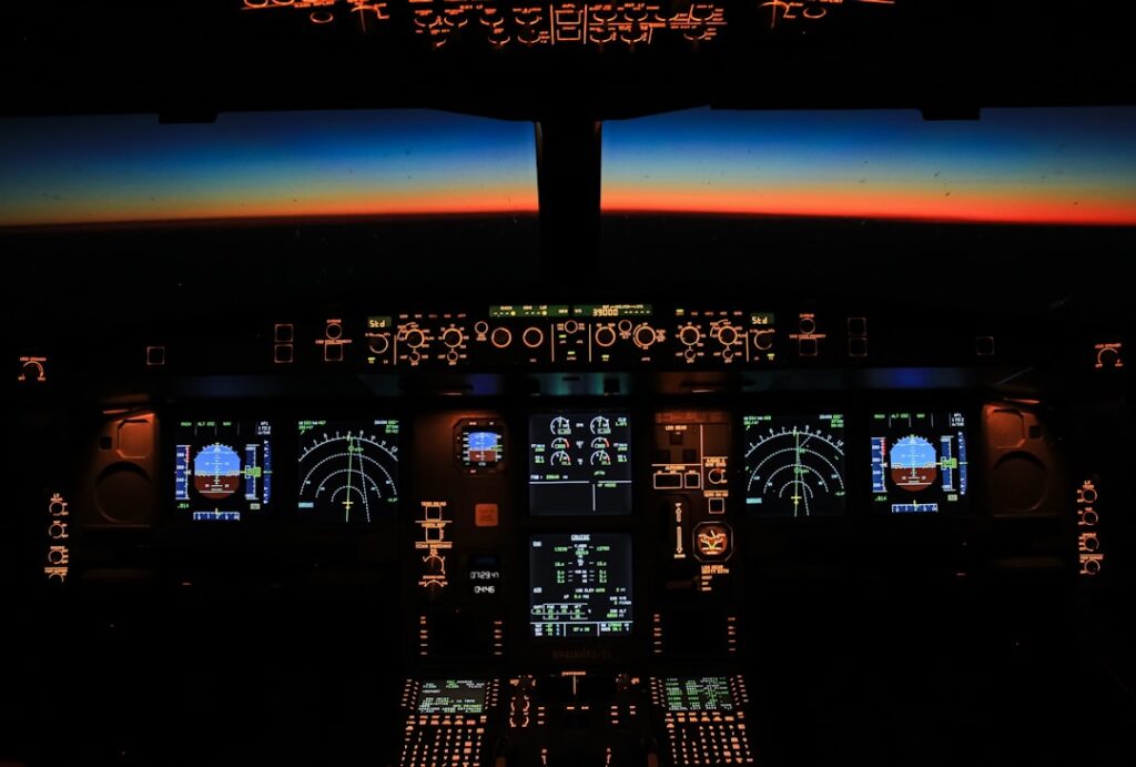 A modern cockpit with advanced flight management systems and digital displays, showcasing the integration of technology in aviation.