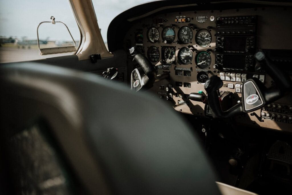 A group of aviation professionals engaged in training exercises with aircraft in the background.